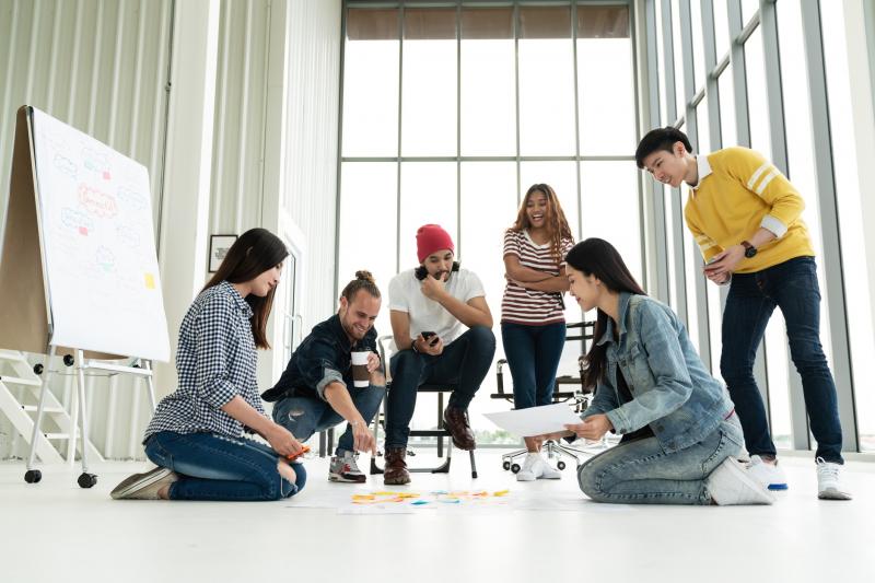 Six young startup entrepreneurs brainstorming for business plan