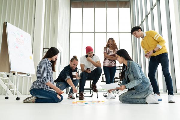 Six young startup entrepreneurs brainstorming for business plan