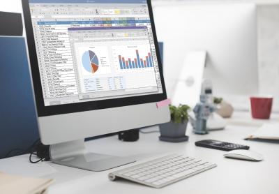 financial charts on computer screen sitting on desk